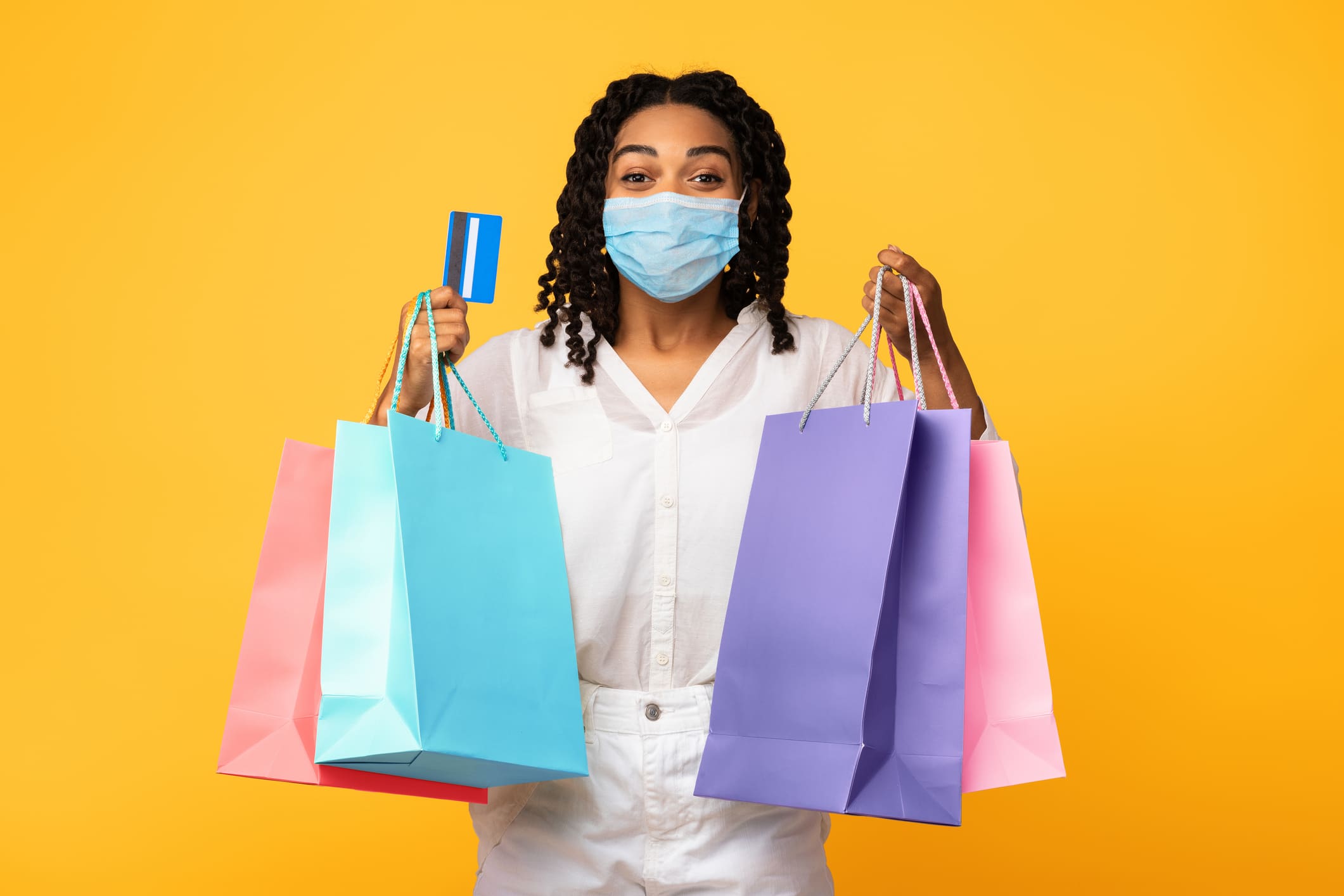 Shopping In Mask Holding Credit Card and Bags